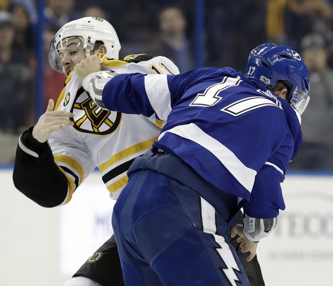 Boston Bruins right wing Jimmy Hayes (11) and Tampa Bay Lightning left wing Alex Killorn (17) fight during the first period of Tuesday's NHL game in Tampa. THE ASSOCIATED PRESS / CHRIS O'MEARA