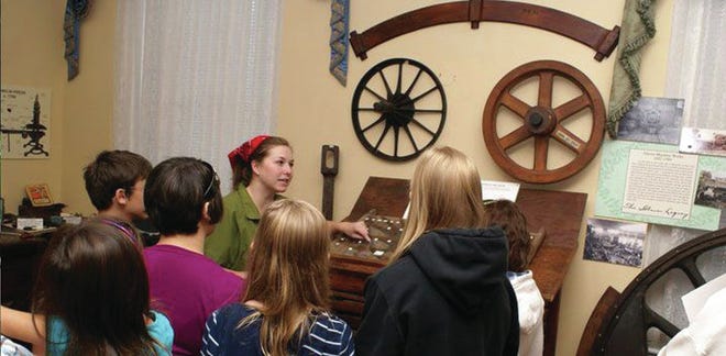 A guide and visitors explore Marietta Museum of History. (Courtesy Marietta Museum of History)