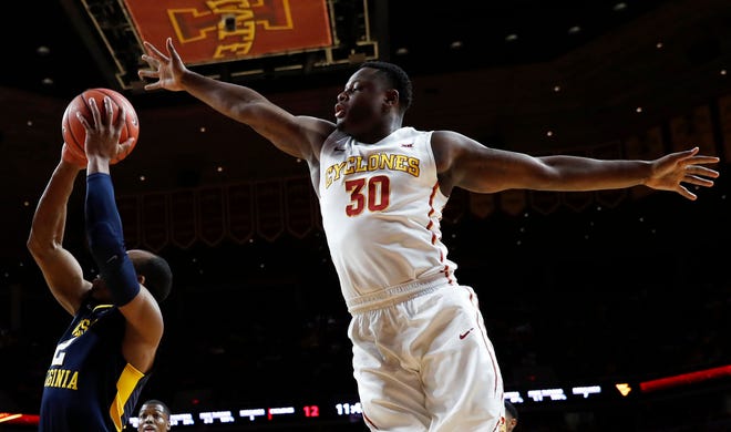 Iowa State guard Deonte Burton (30) tries to block a shot by West Virginia guard Jevon Carter, left, during a game, Tuesday, Jan. 31, 2017, in Ames, Iowa. (AP Photo/Charlie Neibergall)