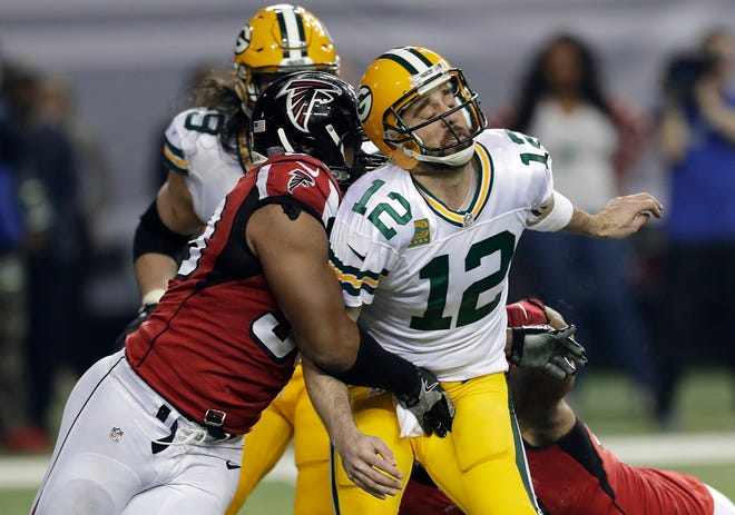 In this Jan. 22, 2017, file photo, Atlanta Falcons defensive end Dwight Freeney (93) hits Green Bay Packers quarterback Aaron Rodgers after throwing a pass during the NFC championship game in Atlanta. Once the season is over, Freeney will think about his future. With his 37th birthday just weeks away, he knows time is running short. But if this is to be his final game, what a way to go out. (David J. Phillip/AP File Photo)