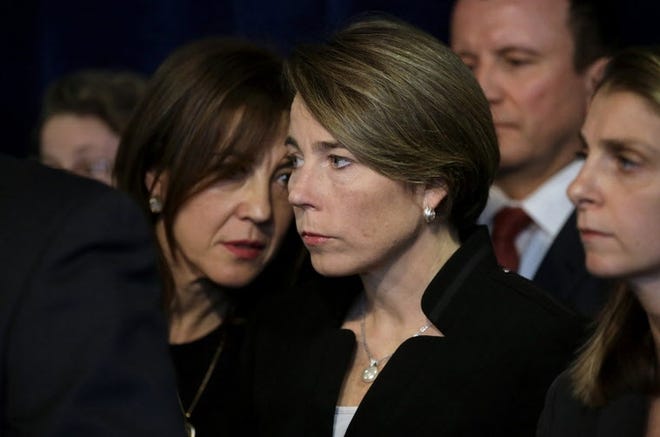 Attorney General Maura†Healey, center, listens to Eva Millona, executive director of the Mass. Immigrant and Refugee Advocacy Coalition, left, during a news conference Tuesday in Boston. Steven Senne/The Associated Press