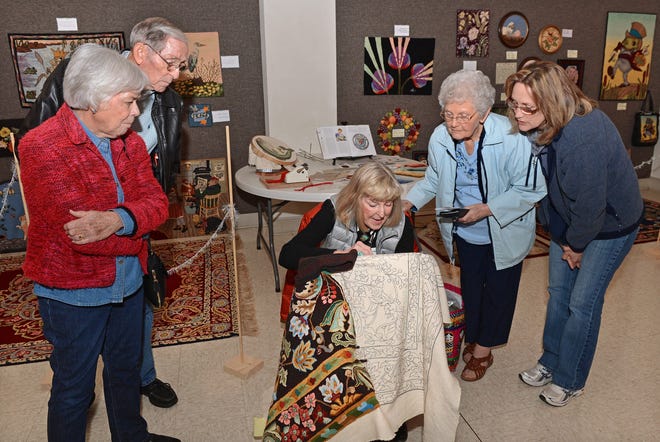 Rex and Nancy Cochran, left, join Paula Friday, from right, and her mother, Peggy Smith, to watch Lee Williams as she works on a rug called"Song of Persia" on Saturday, Jan. 28, 2017. The local fiber arts group"As the Wool Turns," along with other rug hooking artists, presented the Hooked Rug Show at St. Luke Lutheran Church. BRIAN D. SANDERFORD/TIMES RECORD