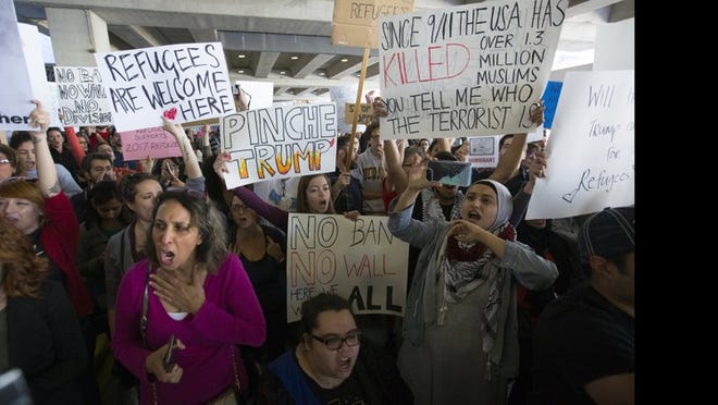 Protesters took to Austin Bergstrom International Airport on Sunday to oppose President Donald Trump’s executive order barring people from seven predominantly Muslim states from entering the U.S.