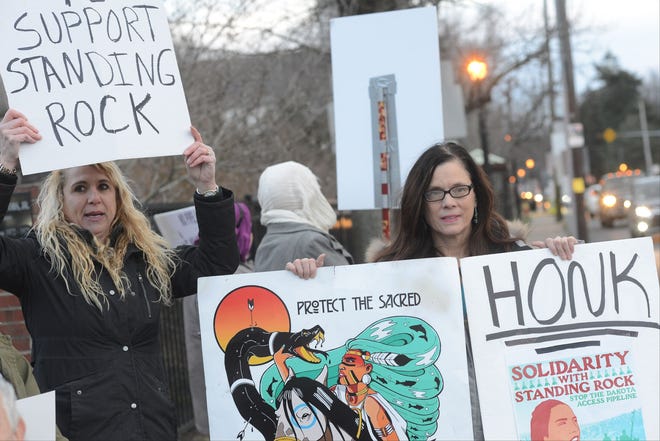 Cathy Leary (left) and Ruthann Tickel-Logan hold signs during a Standing Rock protest in opposition to the impending pipeline Wednesday, Feb. 1, 2017, in Langhorne.