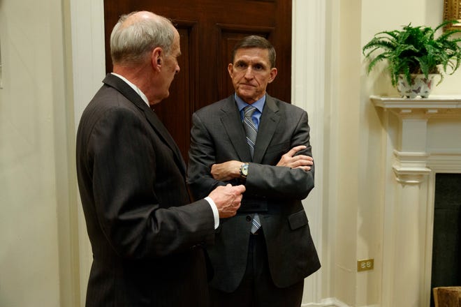 National Security Adviser Mike Flynn, right, talks with Ret. Gen. Keith Alexander before a meeting with President Donald Trump on cyber security in the Roosevelt Room of the White House in Washington, Tuesday, Jan. 31, 2017. (AP Photo/Evan Vucci)