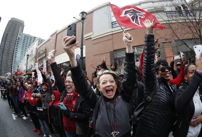 Fans cheer for the Atlanta Falcons Sunday during a sendoff pep rally as they make their way to the airport for a flight to Houston and the Super Bowl. AP PHOTO