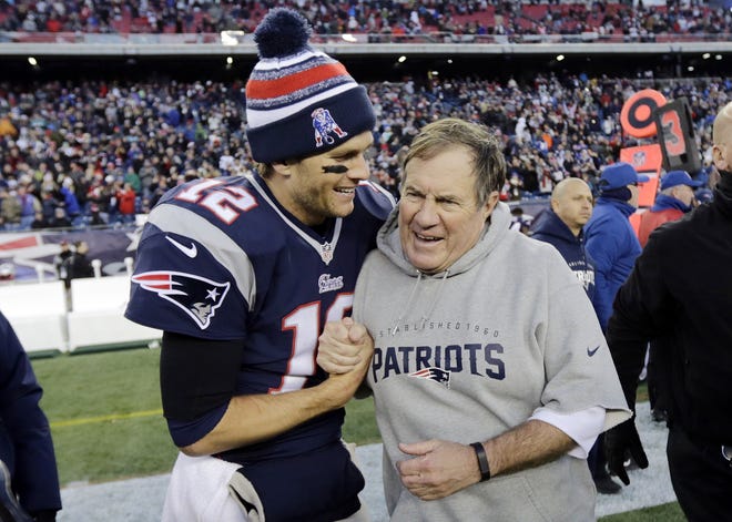 In this Dec. 14, 2014, file photo, New England Patriots quarterback Tom Brady, left, celebrates with head coach Bill Belichick after defeating the Miami Dolphins 41-13 in Foxborough, Mass. THE ASSOCIATED PRESS / CHARLES KRUPA