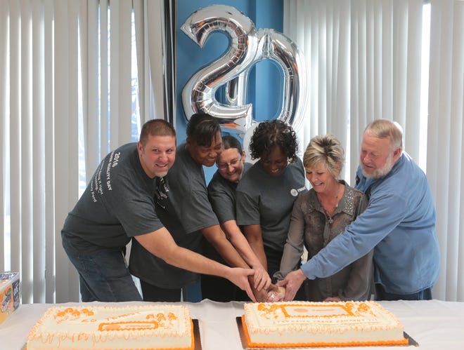 "Day One" employees Earnie Clanton, Dollie Heard, Sherri Stephens, Bunny Warren, Fran Williams and Marc Webb cut the cake at the 20th anniversary celebration for Trane's Lynn Haven plant. The six have been with the plant since its opening in 1996. HEATHER HOWARD/THE NEWS HERALD