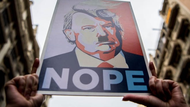 Demonstrators hold posters of Donald Trump during the Women’s March on Jan. 21 in Barcelona.
