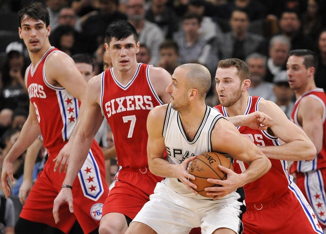 San Antonio Spurs guard Manu Ginobili tangles with the Sixers' Ersan Ilyasova (left) and T.J. McConnell during the first half of Thursday's game in San Antonio.