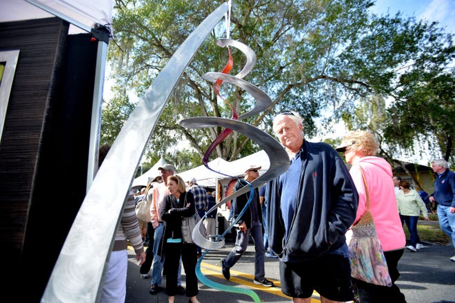 Richard Ball admires a sculpture at last year's Mount Dora Arts Festival. (Amber Riccinto/ Daily Commercial)