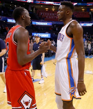 Brothers Jerian, left, and Jerami Grant faced off Wednesday night in Oklahoma City. Their father Harvey, a former NBA forward and OU player, attended his first Thunder home game since Jerami joined the team. [PHOTO BY BRYAN TERRY, THE OKLAHOMAN]