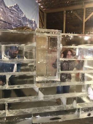 Mark Crouthamel, owner, and Kristen Johnson, business and event manager, at Sculpted Ice Works in Lakeview inside one of many ice scuptures on display during February at the annual Crystal Cabin Fever event. (Photo provided)