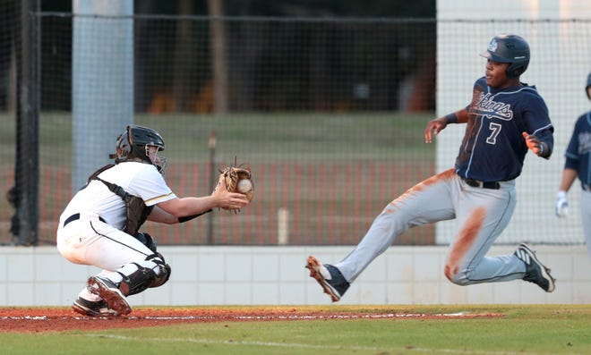 Gulf Coast catcher Josh Nowak prepares to tag out St. John's River baserunner Justin Smith after taking center fielder Jacquez Koonce's throw in the first inning. PATTI BLAKE/THE NEWS HERALD