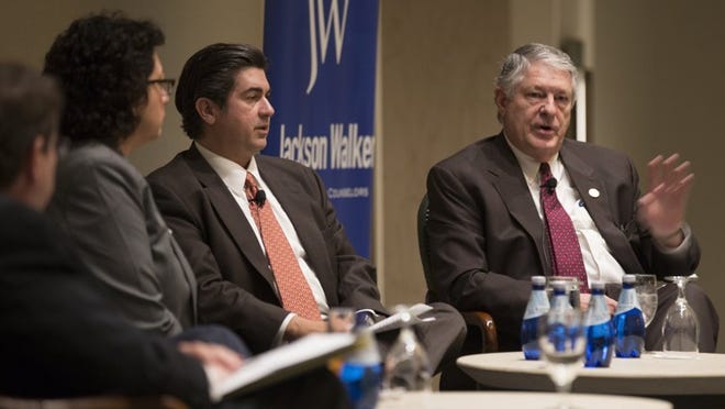State Rep. Paul Workman, right, shown at a panel discussion in January, has filed a series of bills that would affect Austin Energy.