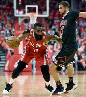 Houston Rockets guard James Harden (13) dribbles around Chicago Bulls guard Michael Carter-Williams during the first half of an NBA basketball game, Friday, Feb. 3, 2017, in Houston. (AP Photo/Eric Christian Smith)