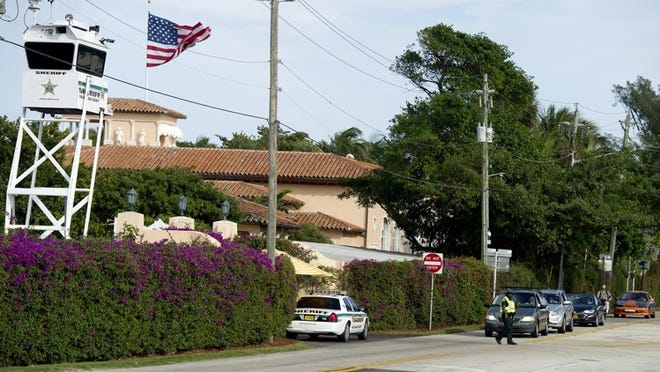 A member of the Palm Beach County Sheriff’s Office directs traffic on Southern Boulevard Friday December 30, 2016 near Mar-a-Lago Club.