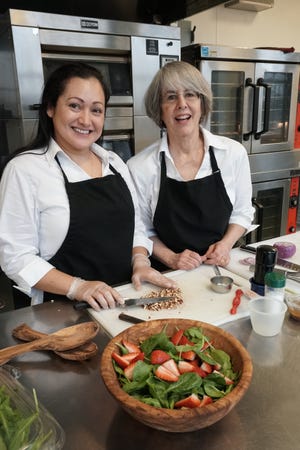 Mary Hughes, right, is launching a prepared-meal business, Savory Fare, to serve elderly people in the Providence area. She is working with her associate, Rosa Munoz, left, in the Hope & Main incubator in Warren. The Providence Journal/Sandor Bodo