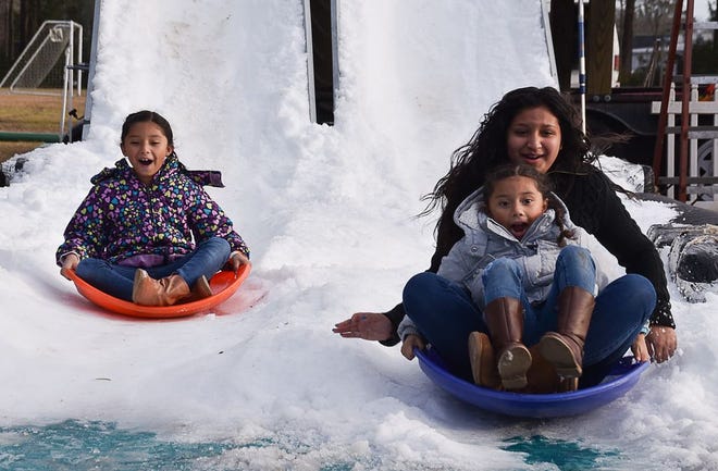 Amanda, Andrea and Alison Acosta go sledding at Swansboro Parks and Recreation’s 2016 Snow Up the Park. This year’s event will be held from noon to 4 p.m. Feb. 4 at the Swansboro Community Center. Daily News file photo