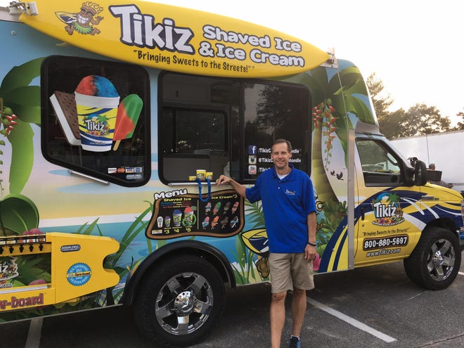 Scott Bailey poses with his Tikiz Shaved Ice & Ice Cream truck. SPECIAL TO THE SUN