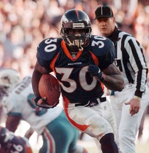 FILE - In this Jan. 9, 1999, file photo, Denver Broncos running back Terrell Davis breaks into the end zone on a 20-yard touchdown run against the Miami Dolphins during an NFL football game in Denver. Davis is part of seven-man class heading into the Pro Football Hall of Fame, it was announced Saturday, Feb. 4, 2017. (AP Photo/Bob Galbraith)