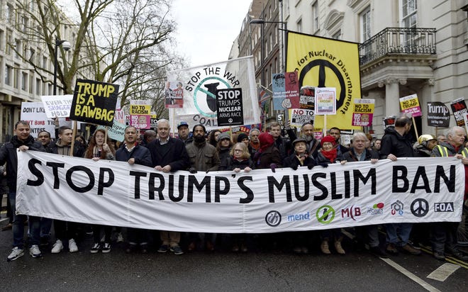 Demonstrators march to Downing Street, as they protest against US President Donald Trump's travel ban, in London, Saturday, Feb. 4, 2017. Thousands of protesters have marched on Parliament in London to demand that the British government withdraw its invitation to U.S. President Donald Trump. Criticism of British Prime Minister Theresa May has swelled since her Washington visit to meet Trump last month, when she confirmed plans for a return visit by Trump to Britain expected in the summer. (David Mirzoeff/PA via AP)