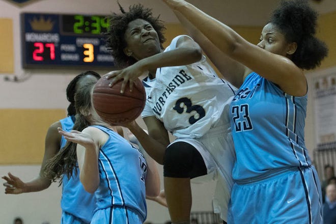 In a collision between two of the area's best players, Northside's Kayla Stephens goes up for a layup as East Duplin's Jonisha McCoy defends during the Monarchs' 41-40 East Central 2-A Conference win Friday night.