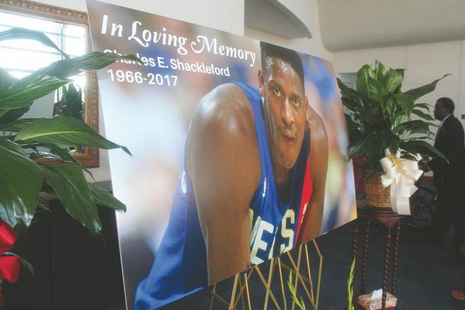 A poster framed by flowers pays homage to the life of Kinston native, NC State Basketball star and NBA star, Charles Shackleford at the Kinston High School Performing Arts Center on Saturday afternoon.