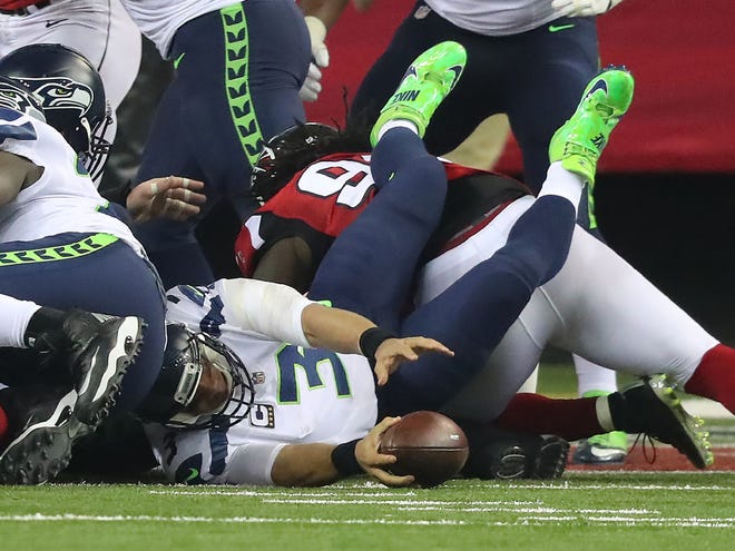 The Falcons defense upends Seahawks quarterback Russell Wilson in the end zone for a safety during the second quarter of the NFC Divisional Playoff game on Jan. 14 at the Georgia Dome.