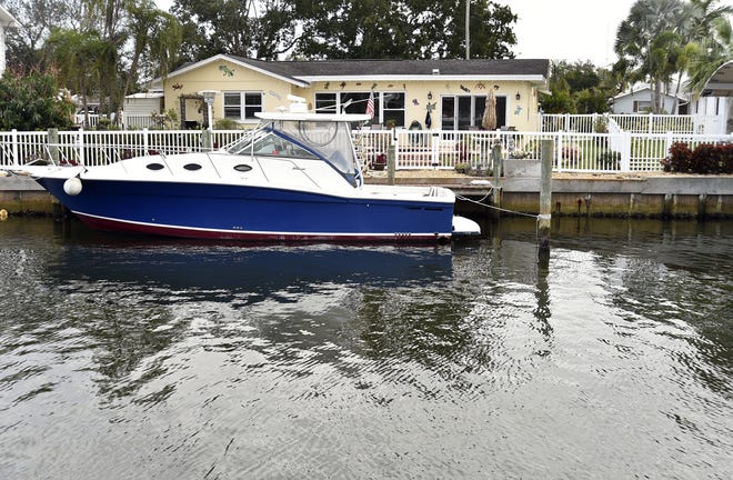 In the Flamingo Cay neighborhood, backyards have docks with boats, some of which seem about as large as the homes. Herald-Tribune staff photo / Thomas Bender
