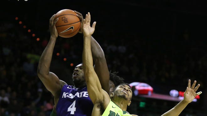 Kansas State forward D.J. Johnson, left, pulls down a rebound over Baylor guard Al Freeman, right, in the first half of an NCAA college basketball game, Saturday, Feb. 4, 2017, in Waco, Texas. (AP Photo/Rod Aydelotte)