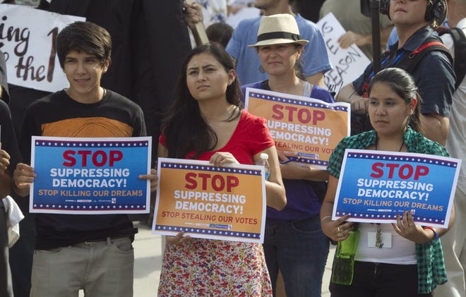 FILE PHOTO: In this Aug. 28, 2012, photo, protesters, including Valerie Morrow, of Lakeland, center right, gather in Ybor Centennial Park during the Dream Act Youth March gathering to protest the Republican National Convention in Tampa.