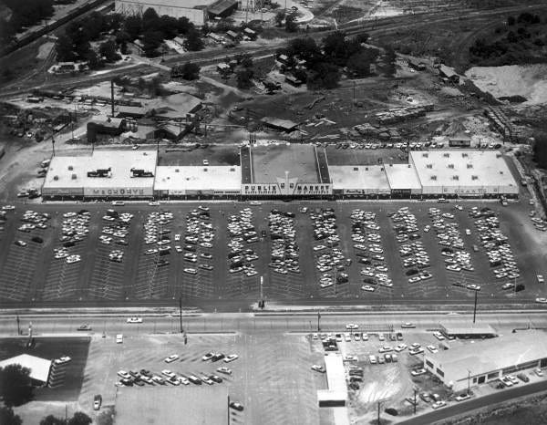 Aerial photo shows the Palm Plaza Shopping Center when it opened in 1961. The Wallings Crate Mill structures sit behind the plaza. SUBMITTED