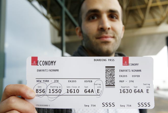 Iranian-born bioengineer researcher Nima Enayati holds up his boarding pass at the Milan's Malpensa International airport in Busto Arsizio, Italy. Just hours after an appeals court blocked an attempt to re-impose the travel ban, Iranian researcher Nima Enayati checked in on an Emirates Airline flight direct from Milan's Malpensa airport to New York's JFK on Sunday afternoon. AP Photo / Antonio Calanni