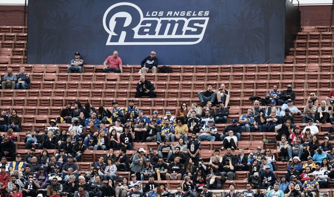 Surrounded by empty seats, Los Angeles Rams fans watch their team play the Atlanta Falcons in an NFL football game on Dec. 11, 2016, in Los Angeles. TV ratings declined 8 percent, with the presidential election partly, but not solely, to blame. Many of the league's highest-profile contests were boring blowouts, including eight of the 10 playoff games leading to Sunday's Super Bowl between the Patriots and Falcons. (AP Photo/Richard Vogel)