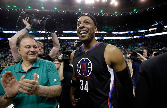 Los Angeles Clippers forward Paul Pierce walks on the court with Boston Celtics co-owner Steve Pagliuca, left, following an NBA basketball game against the Celtics, Sunday, Feb. 5, 2017, in Boston.