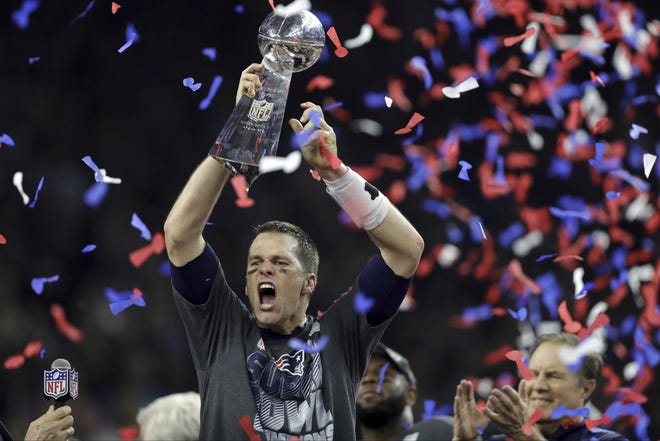 New England Patriots' Tom Brady raises the Vince Lombardi Trophy after defeating the Atlanta Falcons in overtime at Super Bowl LI on Sunday, Feb. 5, 2017, in Houston. The Patriots defeated the Falcons 34-28. THE ASSOCIATED PRESS / DARRON CUMMINGS