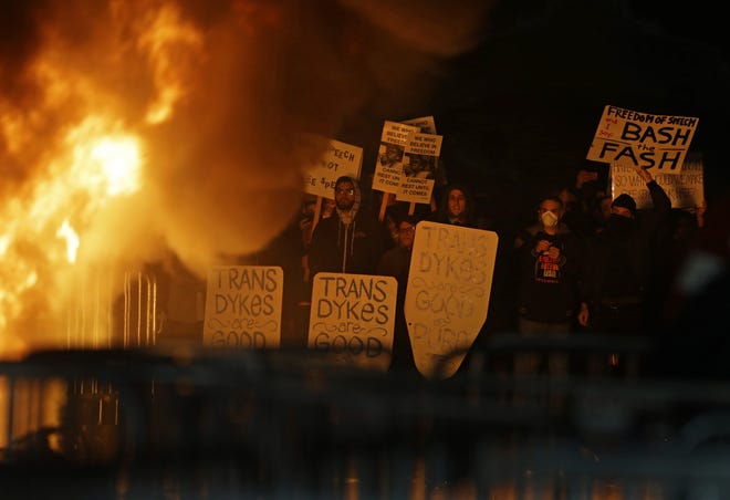 Protestors watch a fire on Sproul Plaza during a rally against the scheduled speaking appearance by Breitbart News editor Milo Yiannopoulos on the University of California at Berkeley campus on Wednesday, Feb. 1, 2017, in Berkeley, Calif. The event was canceled out of safety concerns after protesters hurled smoke bombs, broke windows and started a fire. (AP Photo/Ben Margot)