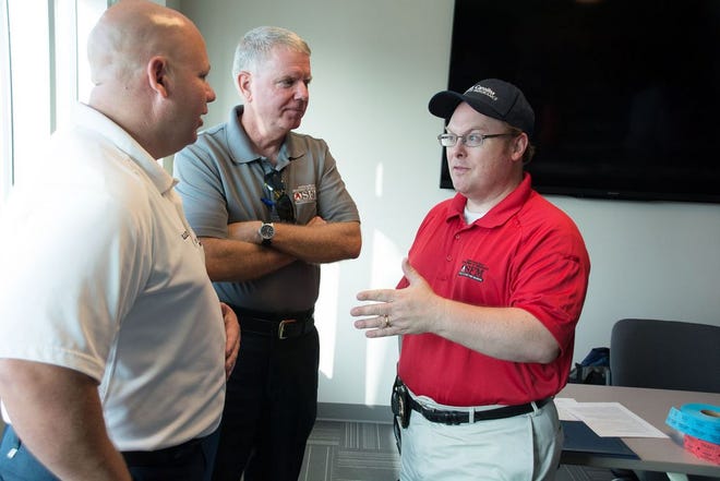 In this file photo, Jacksonville Fire Department Deputy Chief Spencer Lee, right, talks to the former Fire Chief of Onslow Jacksonville and now North Carolina Assistant State Fire Marshall Rick McIntyre and guess speaker North Carolina State Fire Marshal and Commissioner of Insurance Wayne Goodwin at the 2015 Eastern Carolina Firefighters meeting. Lee has accepted the position of fire chief with the Statesville Fire Department. Daily News file photo