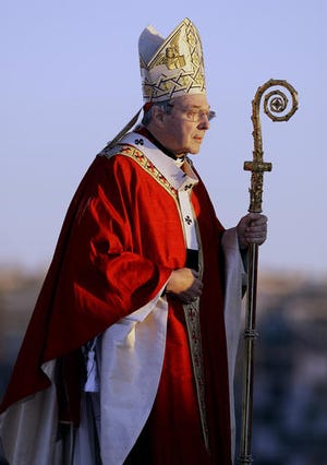 In this 2008 file photo, Cardinal George Pell walks onto the stage for the opening mass for World Youth Day in Sydney, Australia. Seven percent of priests in Australia's Catholic Church were accused of sexually abusing children over the past several decades, a lawyer said on Monday. Cardinal Pell has previously testified before the commission about how church authorities responded to allegations of child sex abuse during his time in Australia.