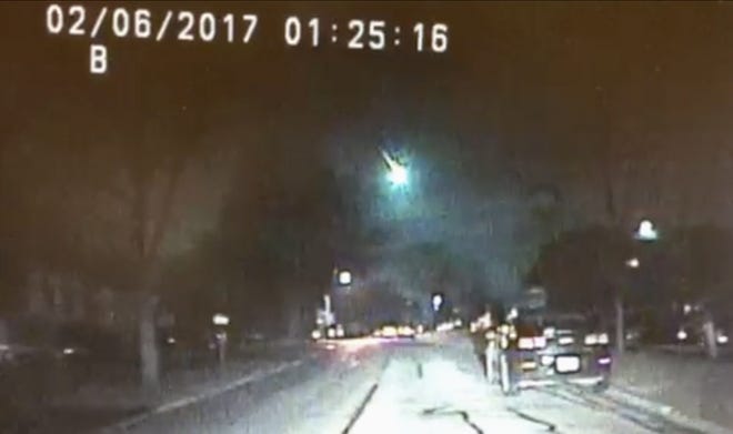 This image from a dashcam video provided by the Lisle Police Department in Lisle, Ill., shows a meteor as it streaked over Lake Michigan early Monday morning, Feb. 6, 2017. The meteor lit up the sky across several states in the Midwest. (Lisle (Ill.) Police Department via AP)