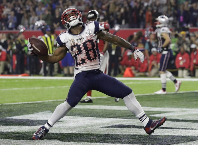 Patriots running back James White celebrates after scoring a touchdown during the second half of Super Bowl 51 Sunday against the Atlanta Falcons in Houston. [Chuck Burton/The Associated Press]