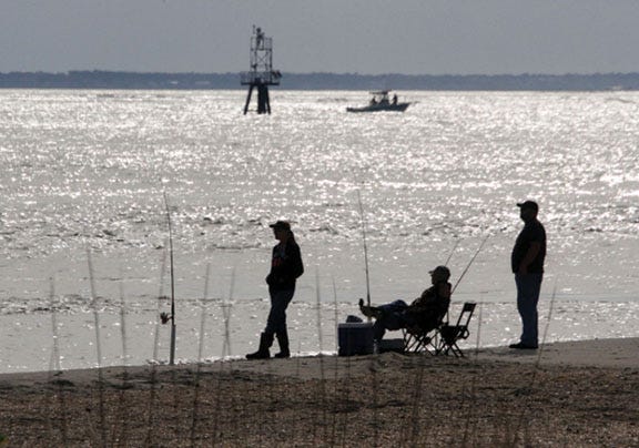 Anglers try their luck at Beaufort Inlet at Fort Macon State Park. Fishing is a popular activity at the state park.