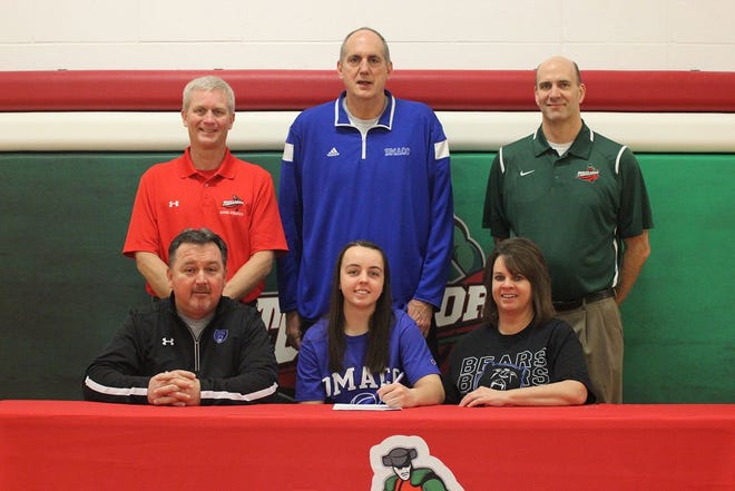 Boone's Emma Rouse (front, center) signs her Letter of Intent to play basketball at DMACC. With Rouse are her parents, John (front, left) and Teresa (front, right), and, from left, Boone assistant coach John Bachman, DMACC coach Steve Krafcisin and Boone head coach Jim McPartland.