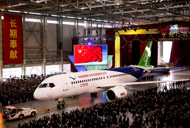FILE - In this Monday, Nov. 2, 2015 file photo, the first twin-engine 158-seater C919 passenger plane made by The Commercial Aircraft Corp. of China (COMAC) is pulled out of the company's hangar during a ceremony near the Pudong International Airport in Shanghai, China. After years of delays, China's first large homemade passenger jetliner will take to the air for its maiden flight in the first half of this year, state media reported Monday, Feb. 6, 2017. (AP Photo, File)
