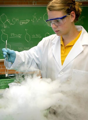 Mowat Middle School eighth-grader Allison Beitzel, 13, works with dry ice during the Sizzling Science event at Gulf Coast Community College in Panama City on Friday.