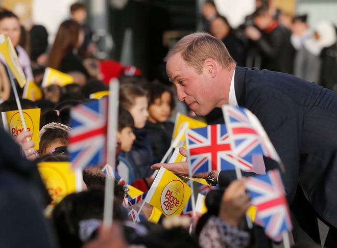 Britain's Prince William speaks to pupils as he and Kate, The Duchess of Cambridge, arrive to attend "The Big Assembly" by Place2Be hosted at Mitchell Brook Primary School in London, Monday. (AP Photo/Frank Augstein)