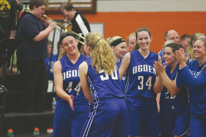 The Ogden Bulldogs girls' basketball team celebrate following its win over Madrid Tuesday. The win completed Ogden's sixth straight sweep of the Tigers.