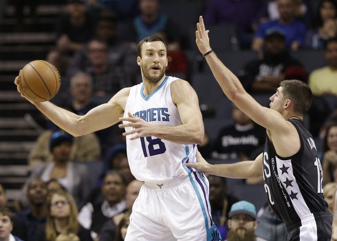 Charlotte Hornets' Miles Plumlee (18) looks to pass as Brooklyn Nets' Joe Harris (12) defends in the first half of an NBA basketball game in Charlotte, N.C., Tuesday, Feb. 7, 2017. [AP Photo/Chuck Burton]