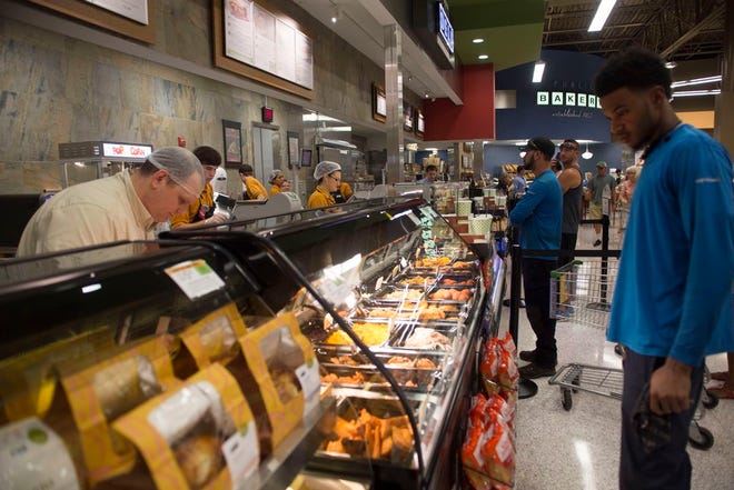 Customers line the deli section at a Publix in Tavares.